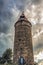 Romantic medieval tower Jungfernturm with a blue white door and a red roof in Grebenstein, Hesse, Germany