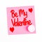 Romantic message on a sticky note saying Be My Valentine with a Love Hearts candy