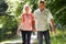 Romantic Middle Aged Couple Walking Along Countryside Path