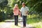 Romantic Middle Aged Couple Walking Along Countryside Path