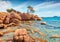 Romantic morning scene of popular touris deastination - Capriccioli beach. Sunny public beach with sand & granite rocks nestled in