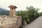 Romantic narrow street with stone fence and chimney in mediterranean village in island Majorca