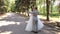 Romantic newly married couple dancing waltz in the park on their wedding day.