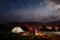 Romantic pair tourists sitting by bonfire under cloudy sky