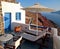 Romantic patio with sun beds and umbrella on Santorini , Greece