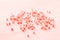 Romantic pattern of pink tinted beads scattered on a soft pink background, festive pattern for wedding design close-up. Hobby,