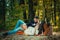 Romantic picnic forest. Couple in love tourists relaxing on picnic blanket. Romantic date in nature. Tourism concept