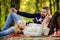 Romantic picnic forest. Couple in love tourists relaxing on picnic blanket. Vacation weekend picnic camping and hiking