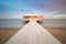 Romantic Pier on water with real Rainbow, long exposure, sunset time