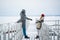 Romantic rendezvous of two lovers on valentine's day on a pier on a frozen river