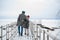 Romantic rendezvous of two lovers on valentine's day on a pier on a frozen river