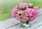 romantic round bouquet of pink hydrangea in a glass vase put on a table