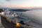 Romantic Santorini island during sunset, Greece. Picturesque view of the city of Santorini. White buildings, sea, mountains.
