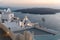 Romantic Santorini island during sunset, Greece. Picturesque view of the city of Santorini. White buildings, sea, mountains.