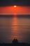 Romantic scene of couple watching beautiful sea at sunset