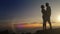 Romantic scene at sunset: couple kissing on their honeymoon