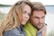 Romantic seaside couple relaxing in sand dune - autumn, beach