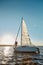 Romantic senior couple enjoying amazing sunset while standing on the side of sail boat or yacht deck floating in the