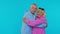 Romantic senior couple man woman grandparents hugging, embracing, looking at camera and smiling