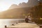 Romantic Senior Couple Sitting On Wooden Jetty By Lake