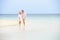 Romantic Senior Couple Walking On Beautiful Tropical Beach