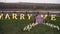 The romantic setting of a marriage proposal, a table decorated with flowers, cutlery, candles and champagne, on a green