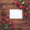Romantic setting red roses and empty paper on wooden board