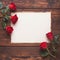 Romantic setting red roses and empty paper on wooden board