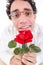 Romantic silly man in love holding red rose