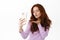 Romantic silly redhead girl sending air kiss at smartphone camera, taking flirty selfie photo, video calling love