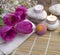 Romantic spa with bath bomb, tulips, candles and pebbles on wooden background.