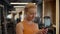 Romantic sportswoman texting message in sport club. Athlete girl standing at gym