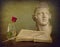 Romantic still life, antique book, quill, red rose, marble bust