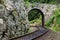 Romantic stone bridge over railway in beautiful forest, Czech republic