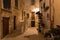 Romantic streets of Polignano a Mare old town by night with poems written on stairs, Apulia region, South of Italy