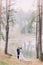 Romantic stroll of newlywed couple on the forest lake sandy shore