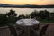 Romantic summer evening in the restaurant - table served for four persons with a sunset view at the lake Marathon, Greece.