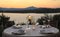 Romantic summer evening in the restaurant - table served for four persons with a sunset view at the lake Marathon, Greece.