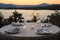 Romantic summer evening in the restaurant - table served for four persons with a sunset view at the lake Marathon, Greece.