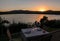 Romantic summer evening in the restaurant - table served for two persons with a sunset view at the lake Marathon, Greece.