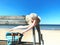 Romantic  summer holiday ,beach and sea . bench on sand . women hat with  white bow  bag ,clothes relaxing sunshine leisure.blue s