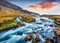 Romantic summer view of small waterfall near Bjodvegur road. Impressive sunrise on Iceland, Vik location