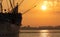 Romantic sunrise over the island of RÃ¼gen with a sailing ship in the foreground.