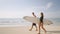 Romantic surfers couple walk, talk with boards on a date. Handsome man, pretty woman in swimwear walk carrying