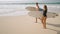 Romantic surfers couple walk, talk with boards on a date. Handsome man, pretty woman in swimwear walk carrying