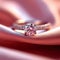 Romantic symbol diamond engagement ring on pink silk fabric Love