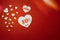 Romantic symbol for sale in the form of a heart with ten percent next to other smaller white hearts on the red background.