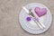 Romantic table setting on light stone concrete background. Valentine`s day or Wedding card template. Lilac felt heart, lavender,