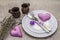 Romantic table setting on light stone concrete background. Valentine`s day or Wedding card template. Lilac felt heart, lavender,