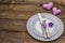 Romantic table setting on vintage wooden boards background. Valentine`s day or Wedding card template. Lilac felt heart, lavender,